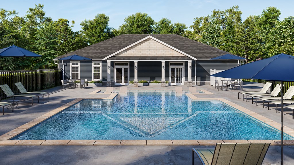 a swimming pool with chairs and umbrellas in front of a clubhouse