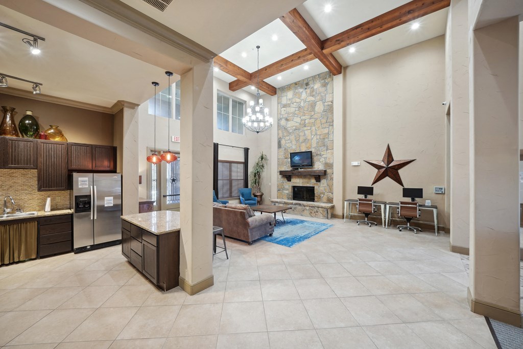 a large living room with a stone fireplace and a tv