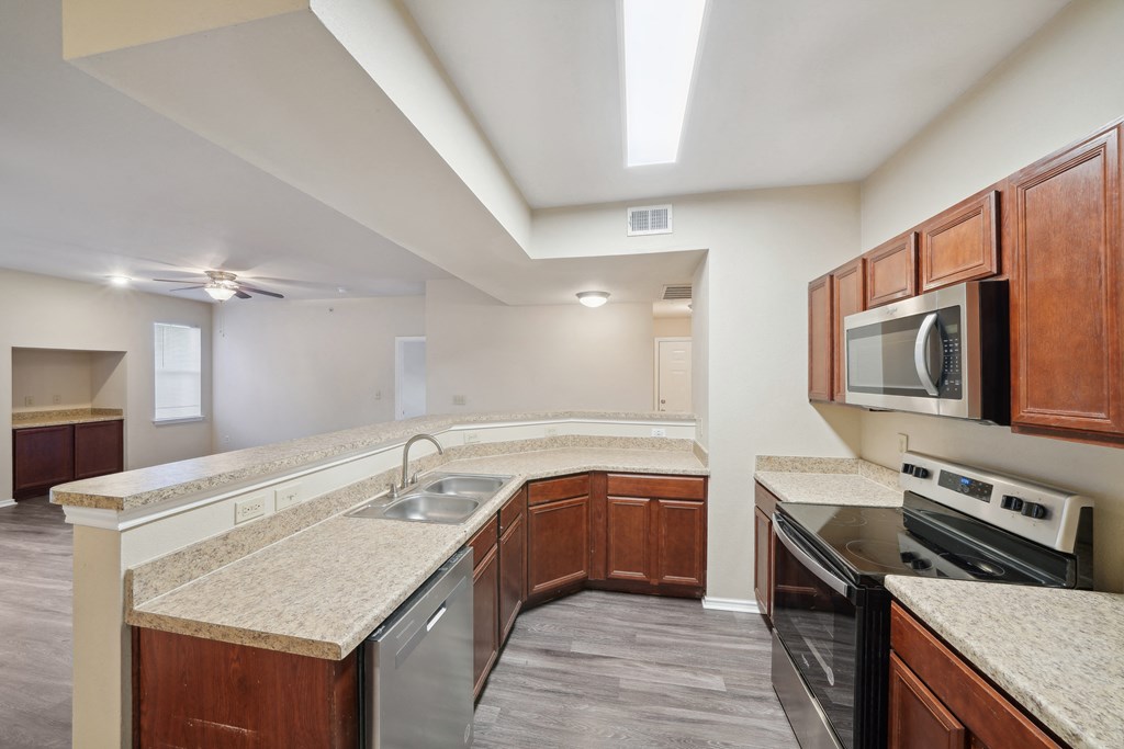 a kitchen with granite counter tops and stainless steel appliances