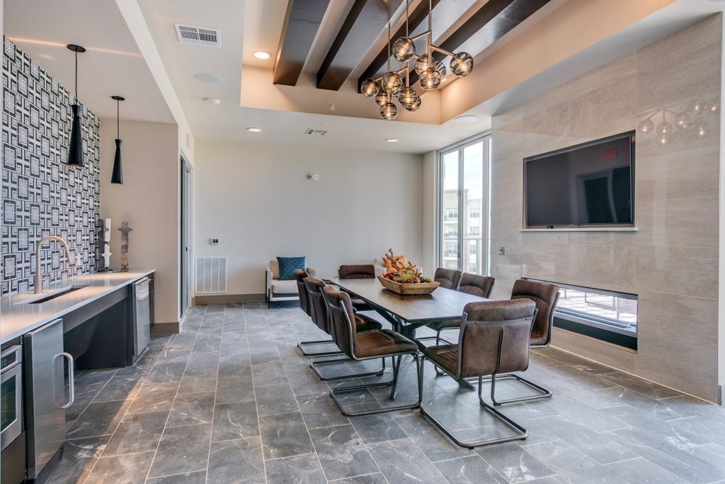 a dining room with a table and chairs and a television
