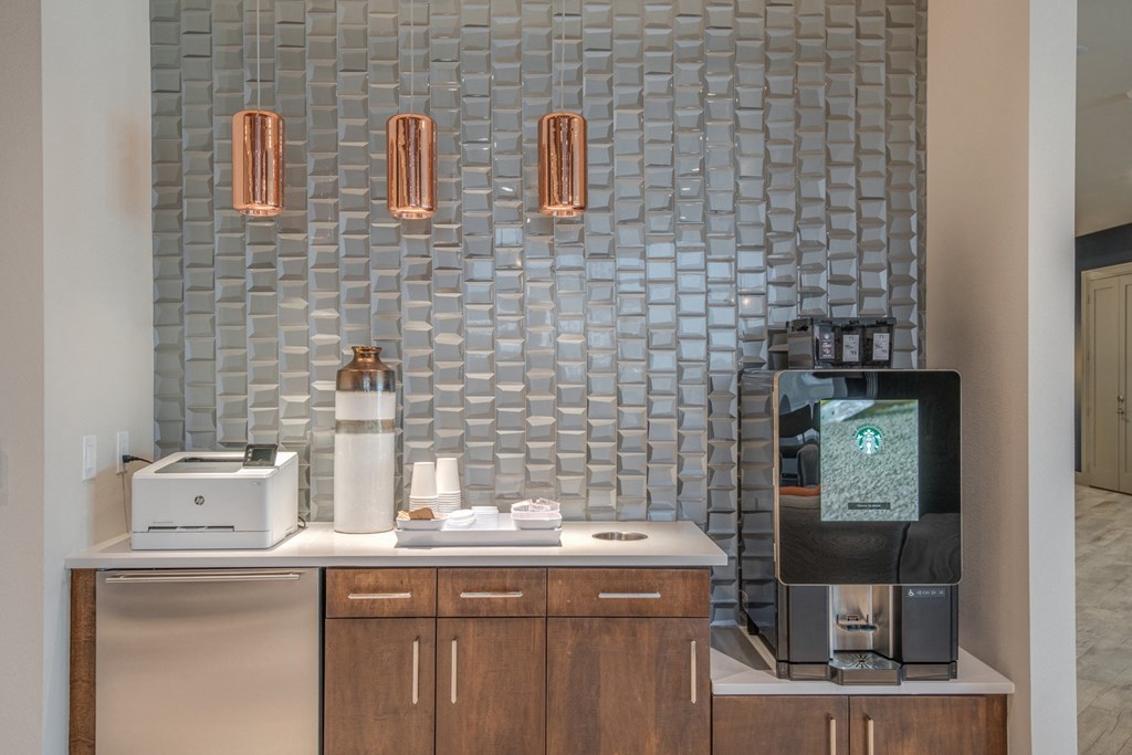 a kitchen with a coffee machine and a counter with a sink and a coffee maker