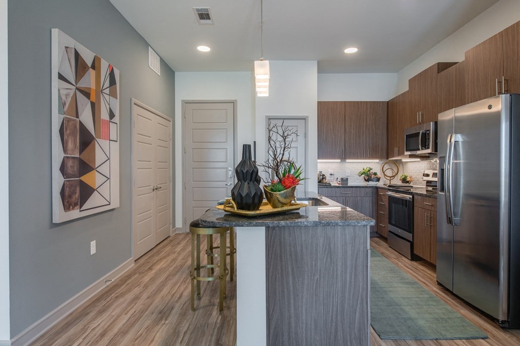 a kitchen with stainless steel appliances and a granite counter top