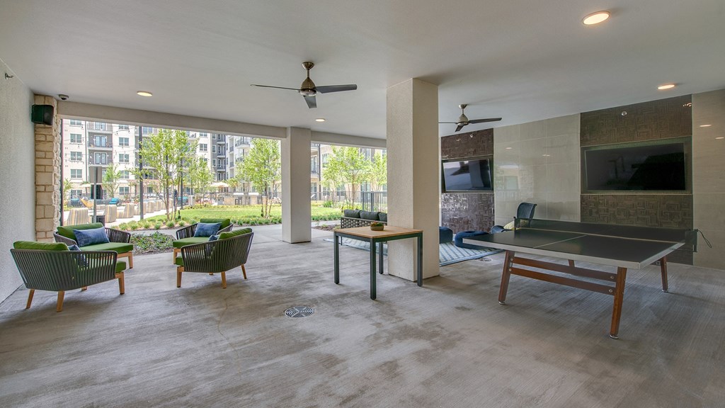 an open living room with a pool table and a television