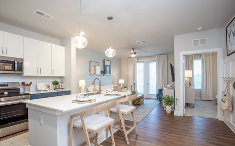 A modern kitchen with a dining table and chairs.