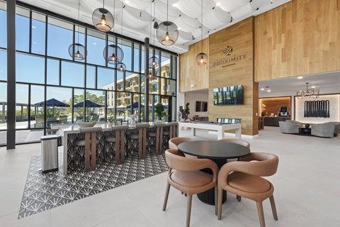 A modern dining area with a large table and chairs.