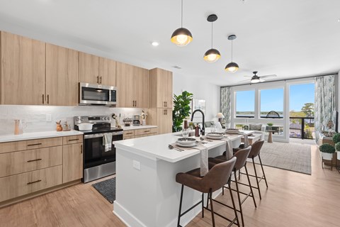 A modern kitchen with a dining table set for four.