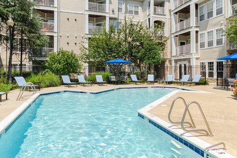 a large swimming pool with a building behind it