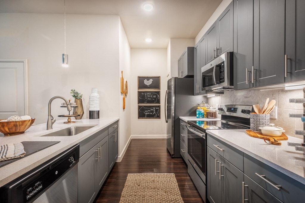 a kitchen with stainless steel appliances and black cabinets