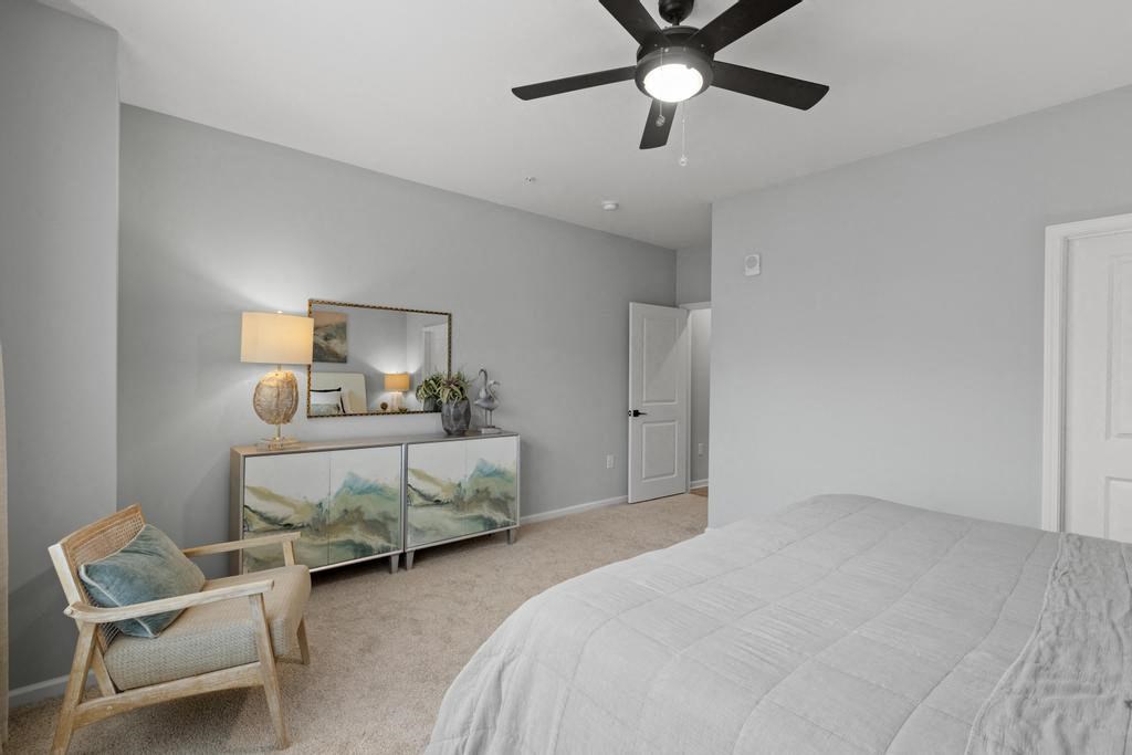 a bedroom with a bed and a ceiling fan