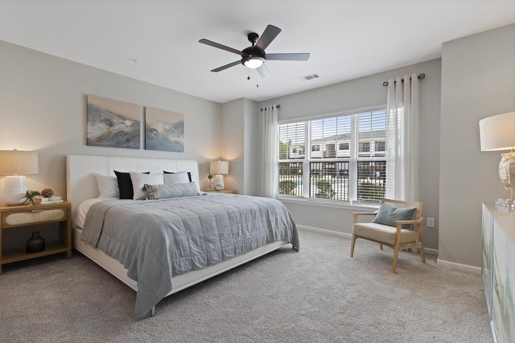a bedroom with a bed and a ceiling fan