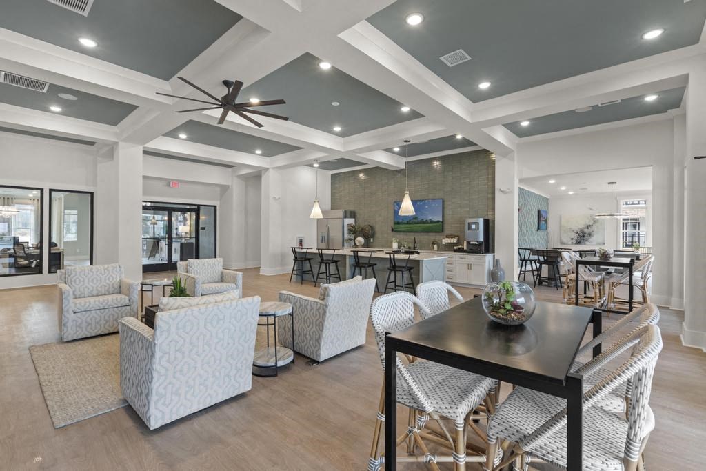 a living room and dining room with a table and chairs