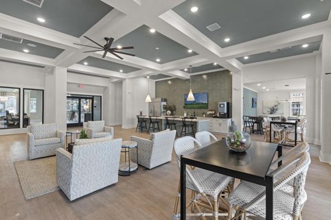 a living room and dining room with a table and chairs