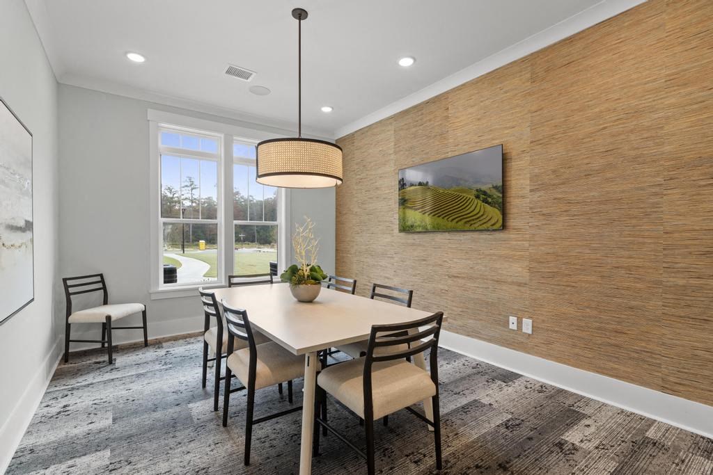 a dining room with a table and chairs