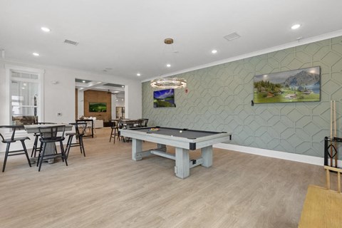 a games room with a pool table and tables