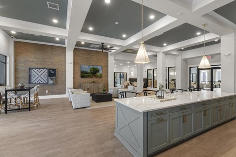 a large kitchen with an island and a living room