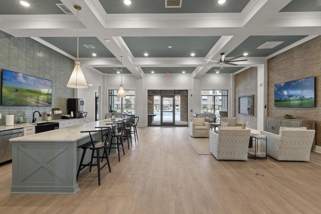 a living room with a bar and a table with chairs