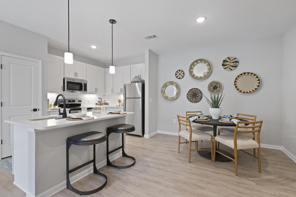 an open kitchen and dining room with a table and chairs