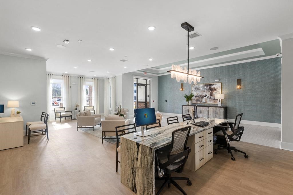 a large office with a desk with chairs and a computer