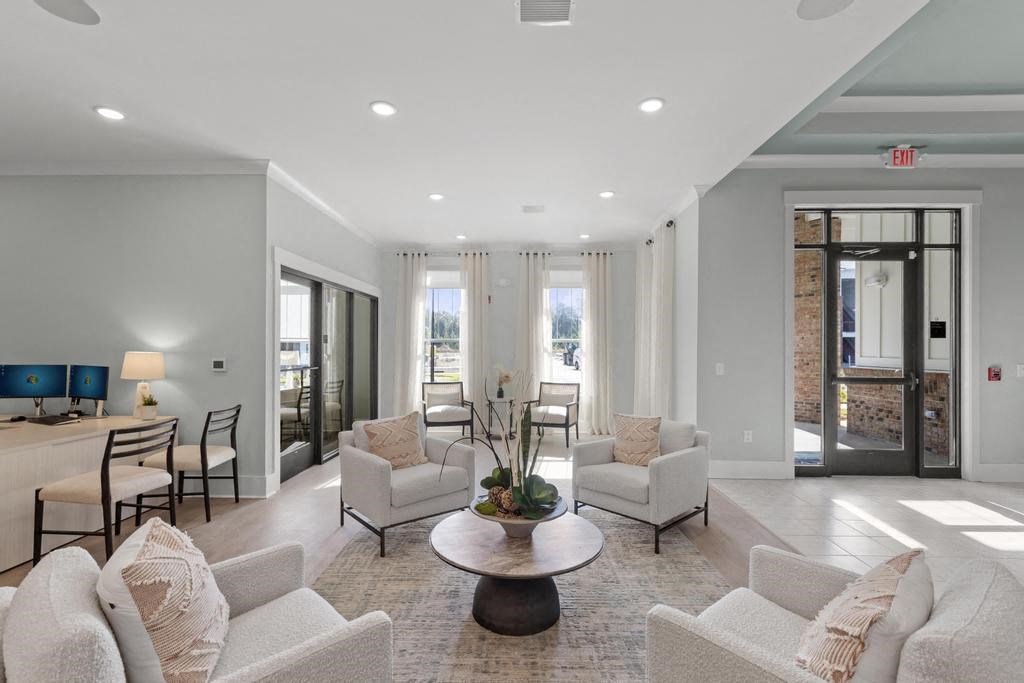 a living room with couches and chairs and a table