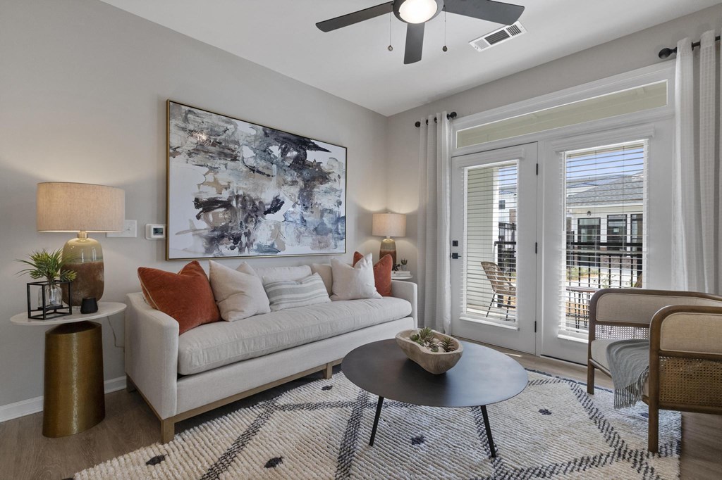 a living room with a couch and a ceiling fan