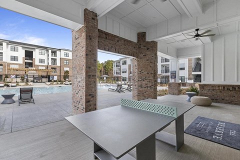 a patio with a pool and a table