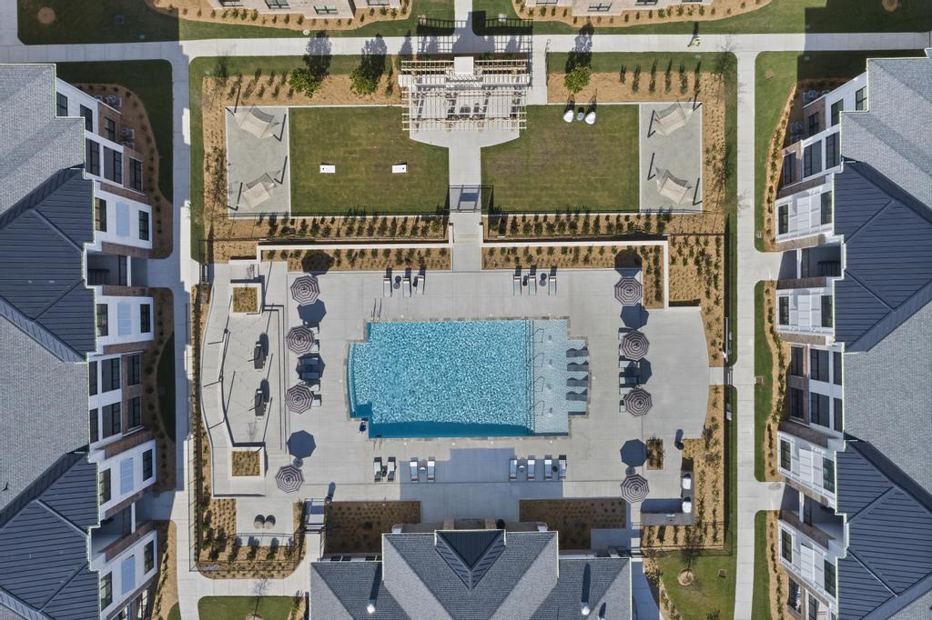 a aerial view of a pool in the middle of a house