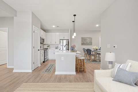 A modern kitchen with white cabinets and a breakfast bar.