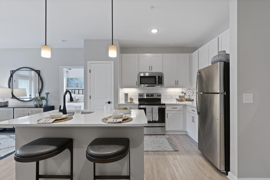 white kitchen with stainless steel appliances