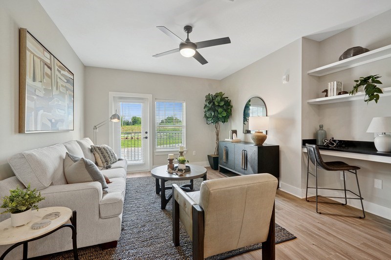 A living room with a couch, chair, and a table in the middle.