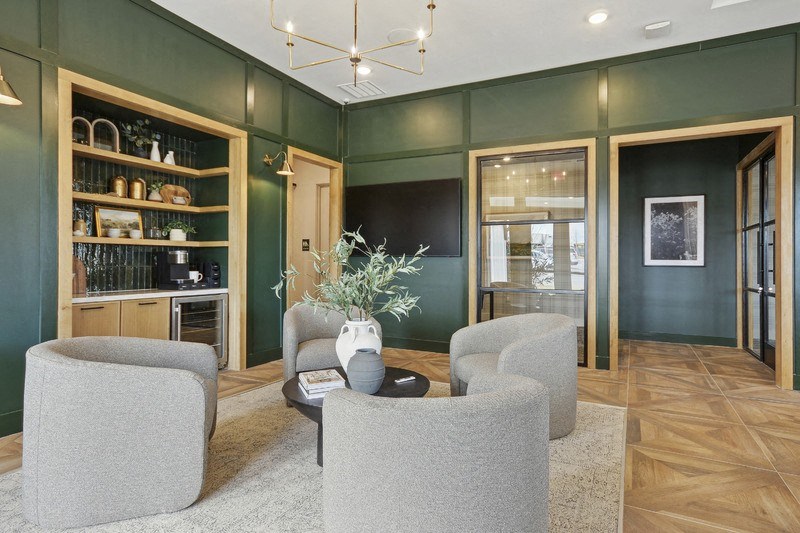 A living room with grey armchairs and a coffee table.