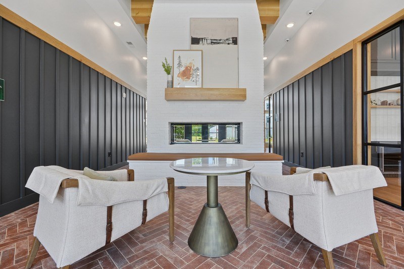 A room with a white sofa and a wooden coffee table.