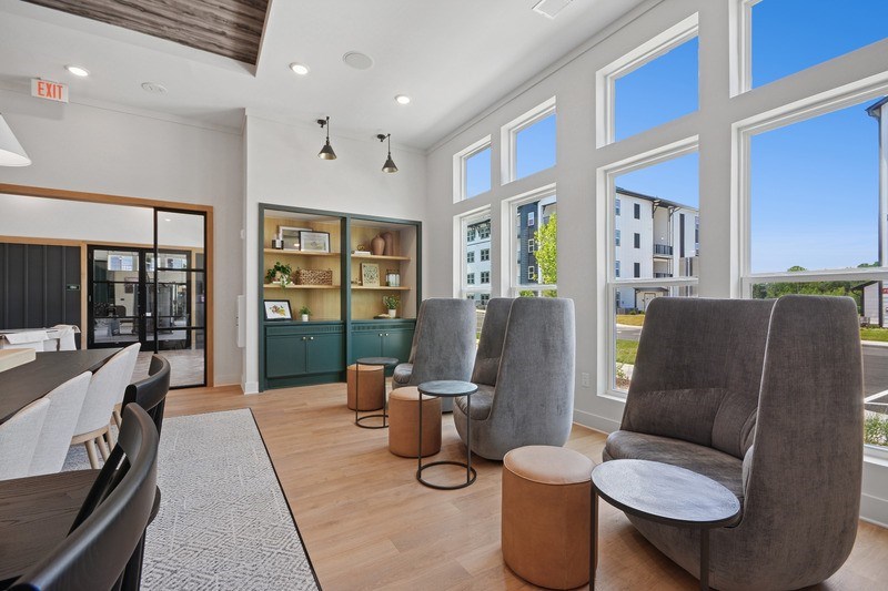 A room with grey chairs and a wooden table.