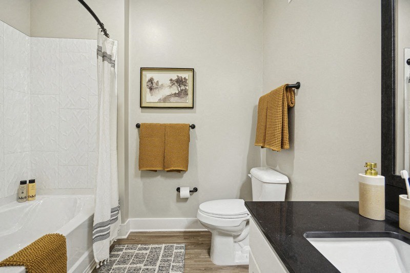 A bathroom with a toilet, sink, and bathtub.