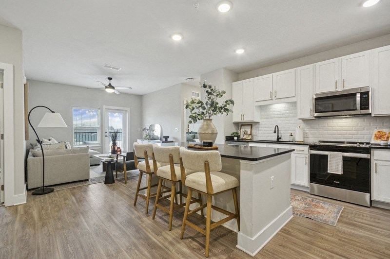 A kitchen with a dining table and chairs.