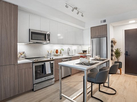 a kitchen with stainless steel appliances and a table