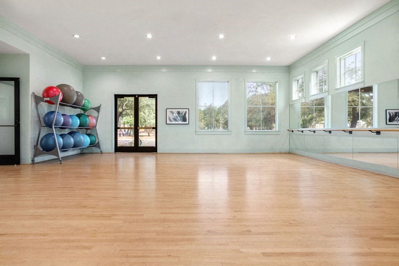 a large room with a wood floor and a glass door