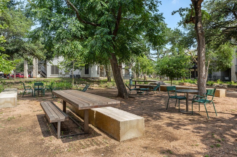 a picnic area with a wooden table and benches