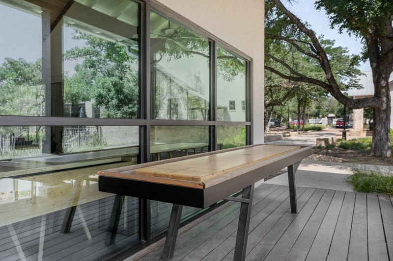 a bench on a deck in front of a window