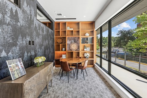 a dining room with a table and chairs and a large window