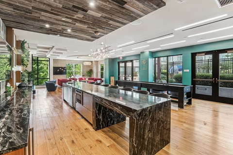the kitchen has a large island with granite counter tops