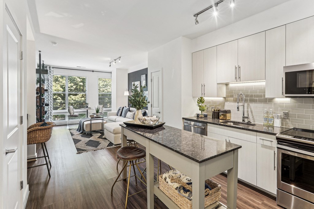a kitchen with a island and a living room with a couch