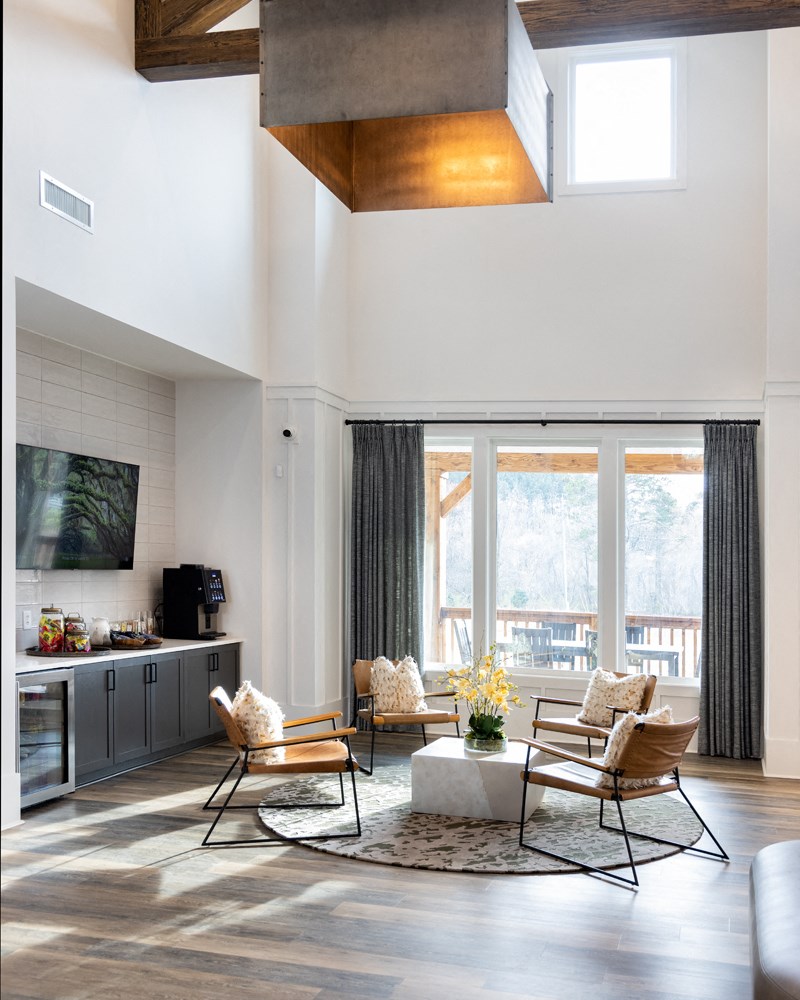A living room with a television, a sofa, a chair and a table.