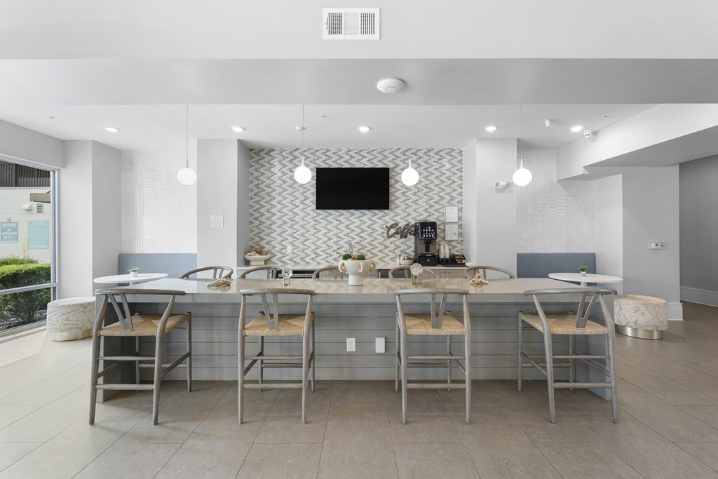A modern kitchen with a long table and chairs.