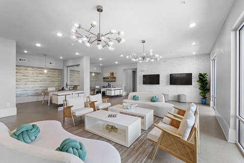 A modern living room with white furniture and a chandelier.