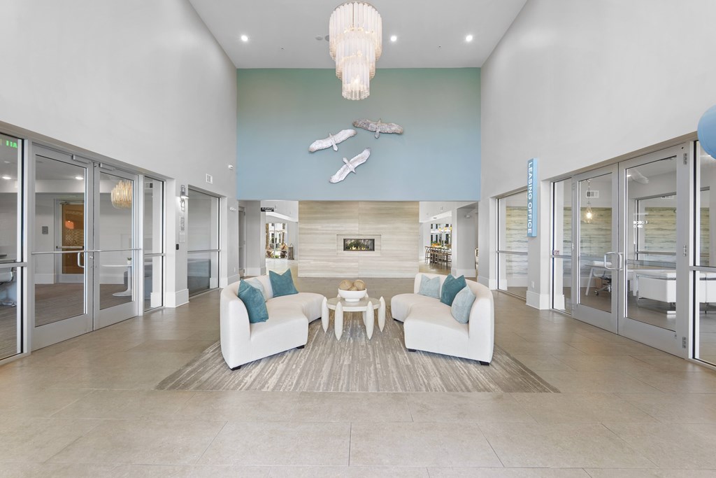 A spacious living room with a white couch and a wooden coffee table.
