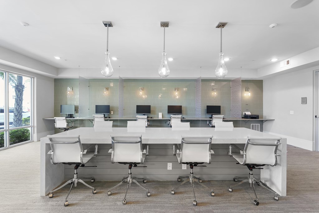 A conference room with a long table and chairs.