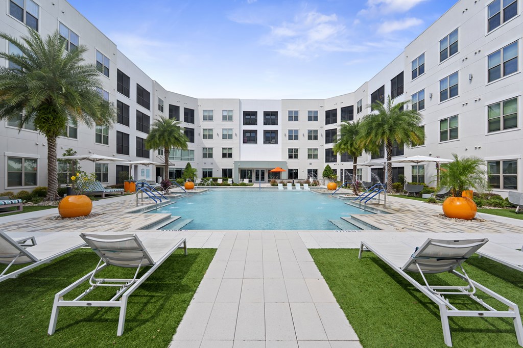 A large white building with a pool in the middle of it.