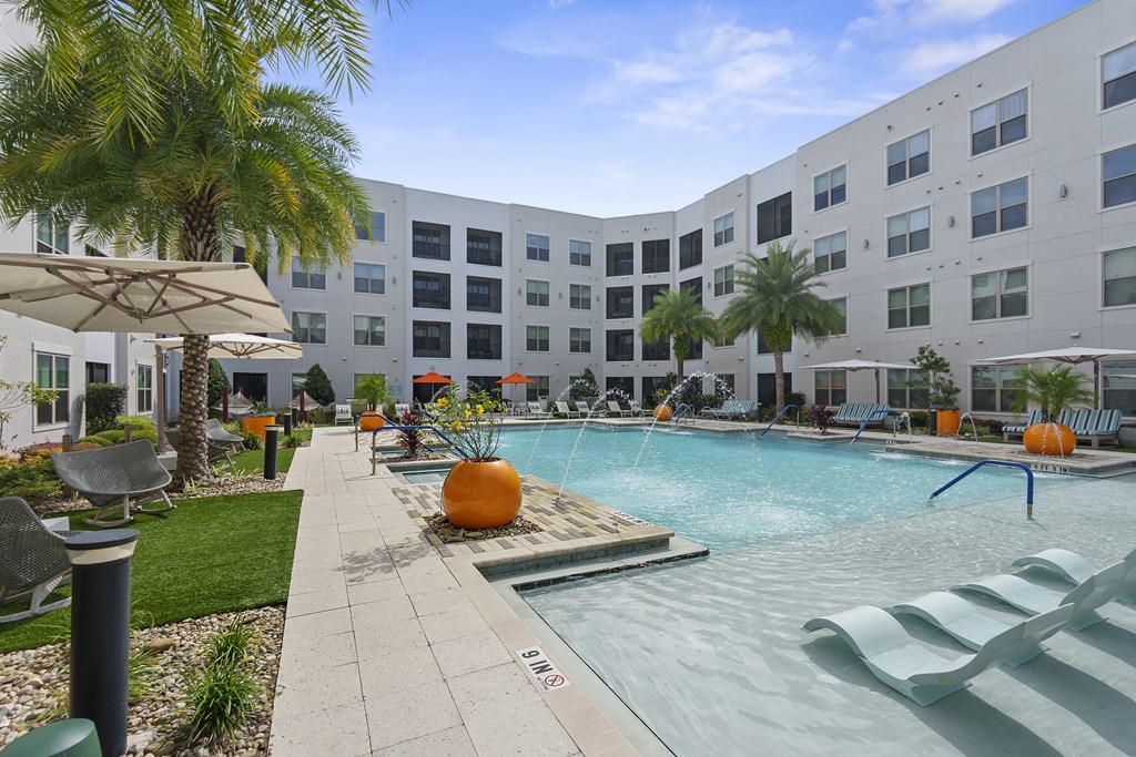 A pool area with a white building in the background.
