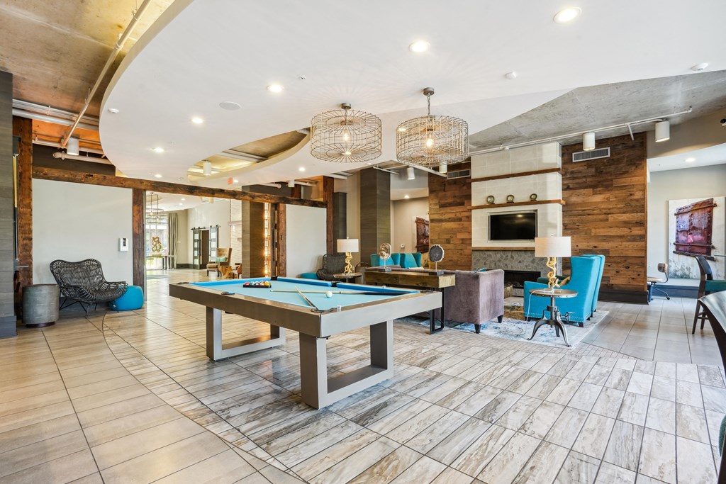 a game room with a pool table and a tv