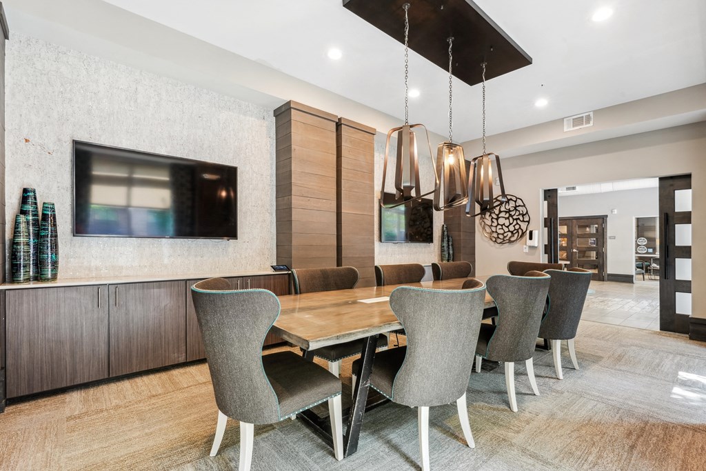a dining room with a long wooden table and chairs